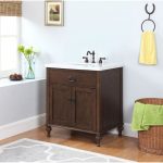 Antique Oak Finish Vanity with Gray and White Stone Marble Top.